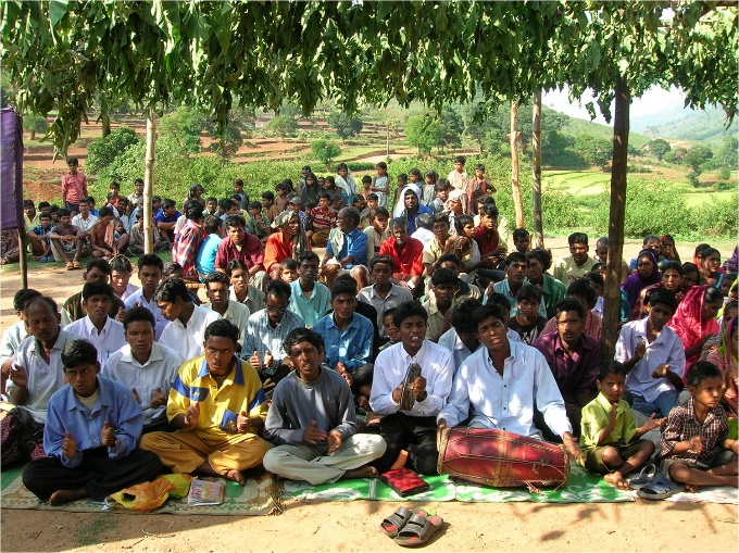 An impromptu crowd gathered in a village to listen to the proclamation about Jesus Christ.